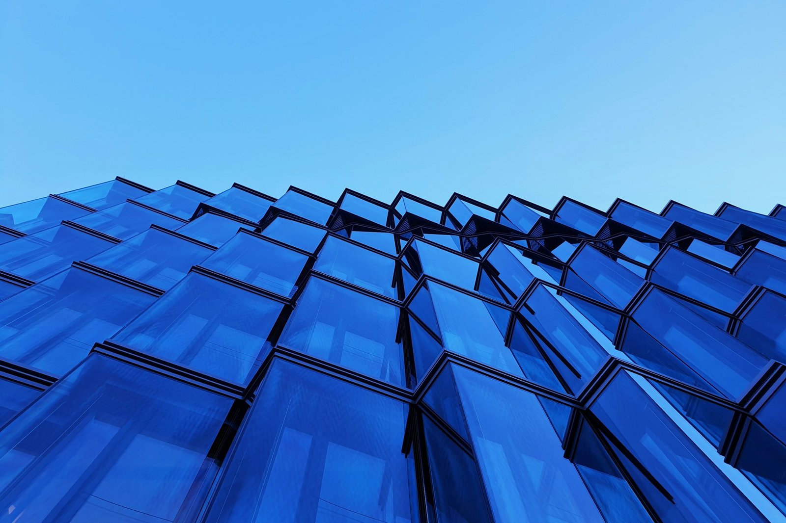 Blue glass architecture against a clear sky